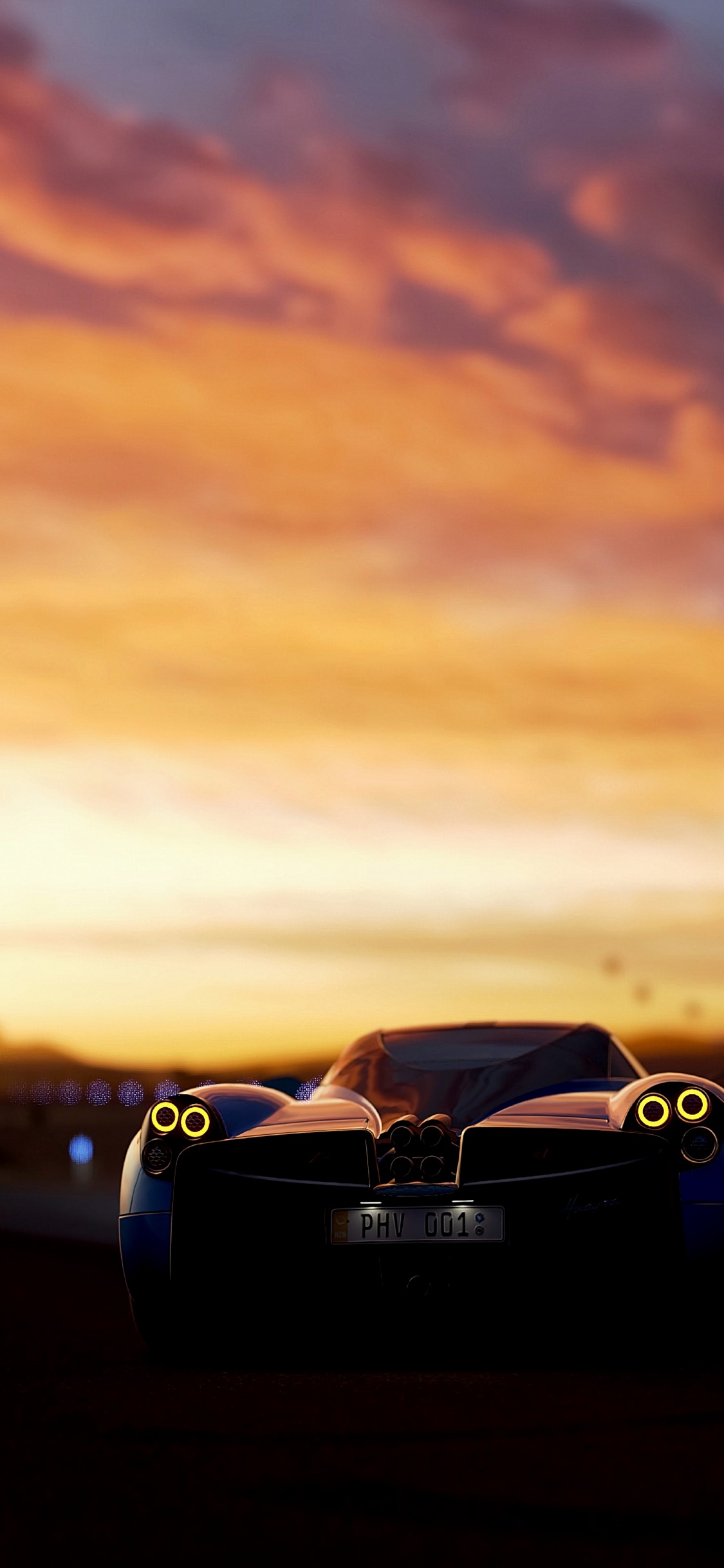 Porsche 911 Negro en la Carretera Durante la Puesta de Sol. Wallpaper in 1125x2436 Resolution