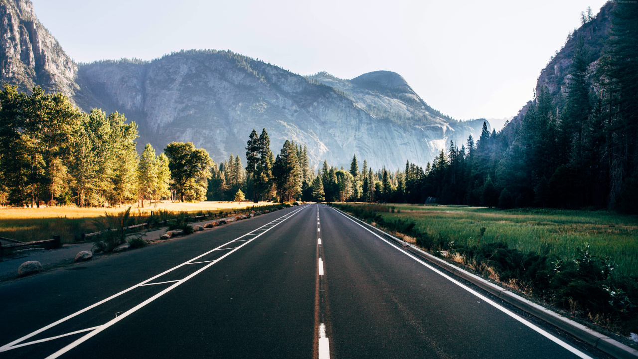 Gray Concrete Road Between Green Trees and Mountain During Daytime. Wallpaper in 1280x720 Resolution
