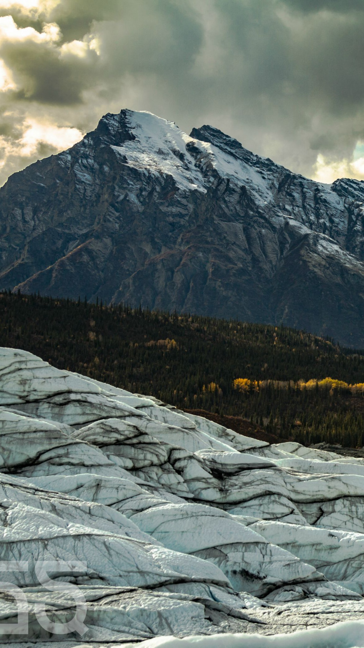 Snow Covered Field and Mountains Under Cloudy Sky During Daytime. Wallpaper in 750x1334 Resolution