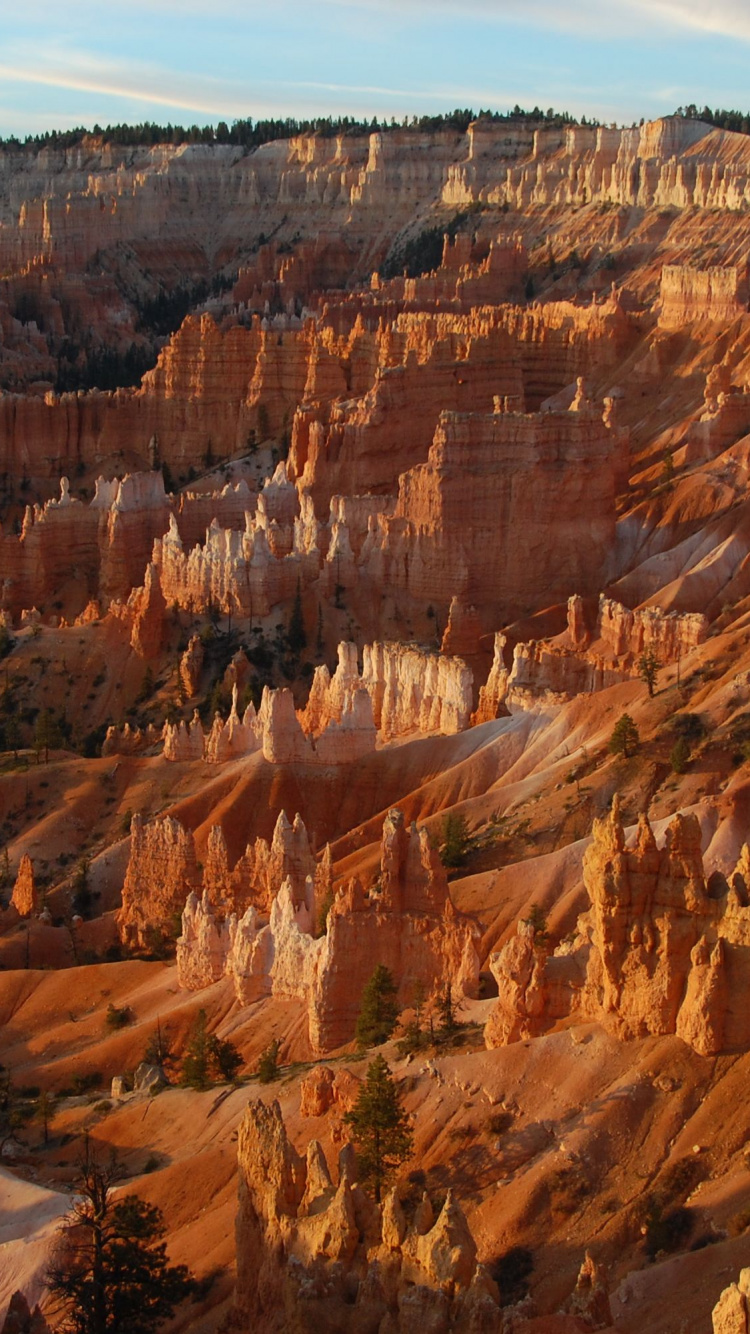 Brown Rocky Mountain Under Blue Sky During Daytime. Wallpaper in 750x1334 Resolution