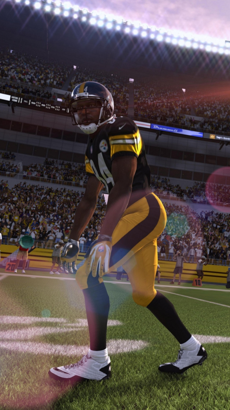 Football Players on Field During Nighttime. Wallpaper in 750x1334 Resolution