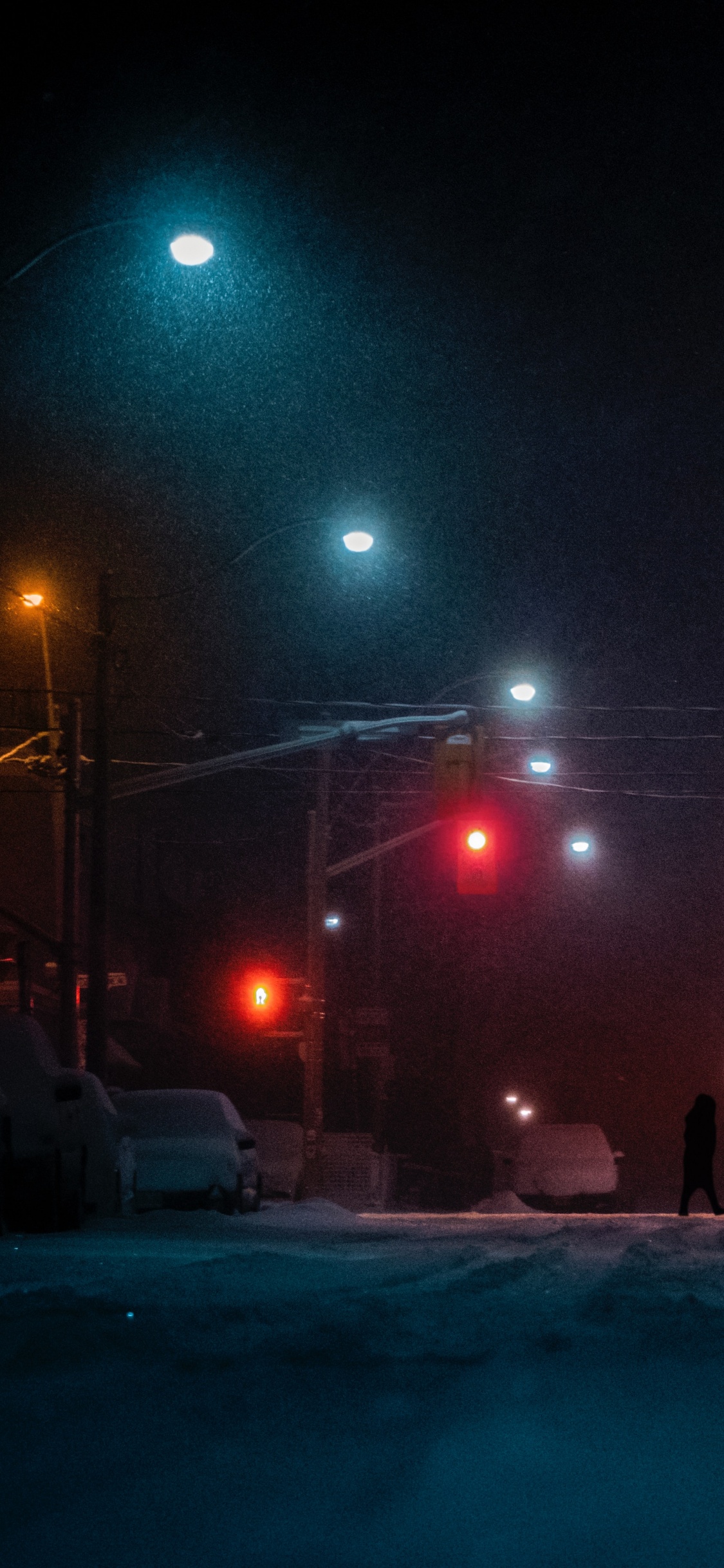Person Walking on Road During Night Time. Wallpaper in 1125x2436 Resolution