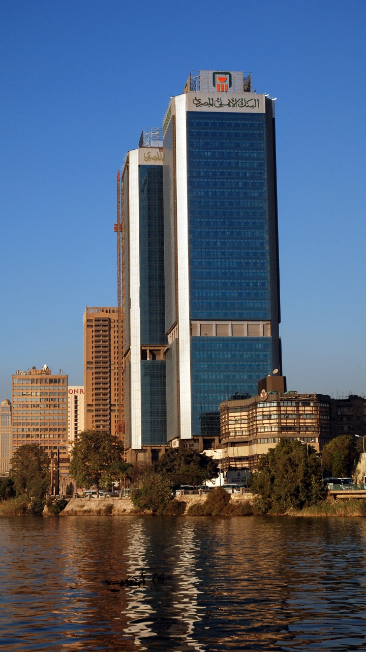 High Rise Building Near Body of Water During Daytime. Wallpaper in 720x1280 Resolution