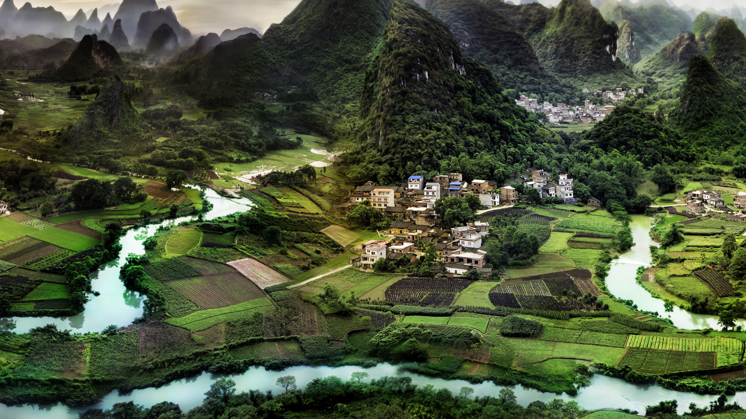 Green and Black Mountain Under Cloudy Sky During Daytime. Wallpaper in 2560x1440 Resolution