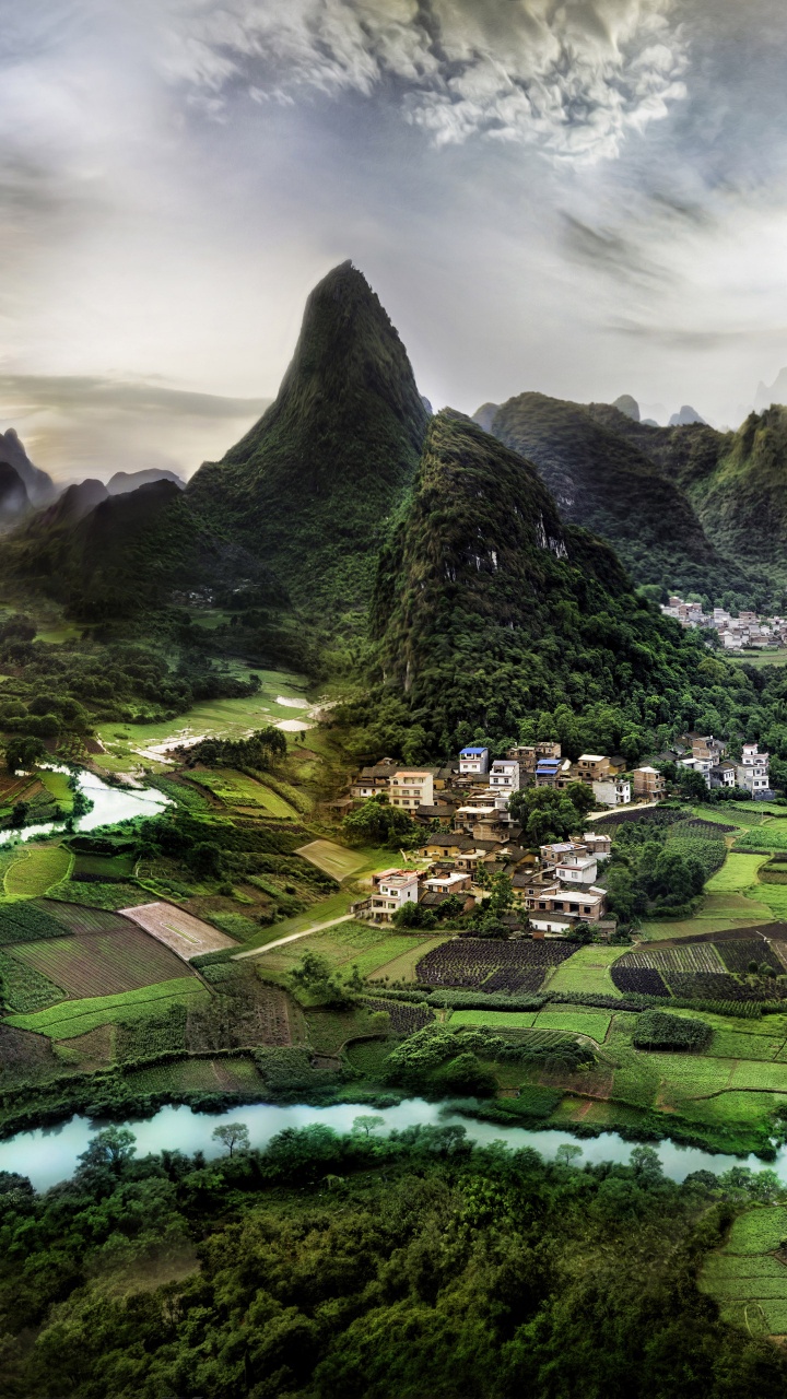 Green and Black Mountain Under Cloudy Sky During Daytime. Wallpaper in 720x1280 Resolution