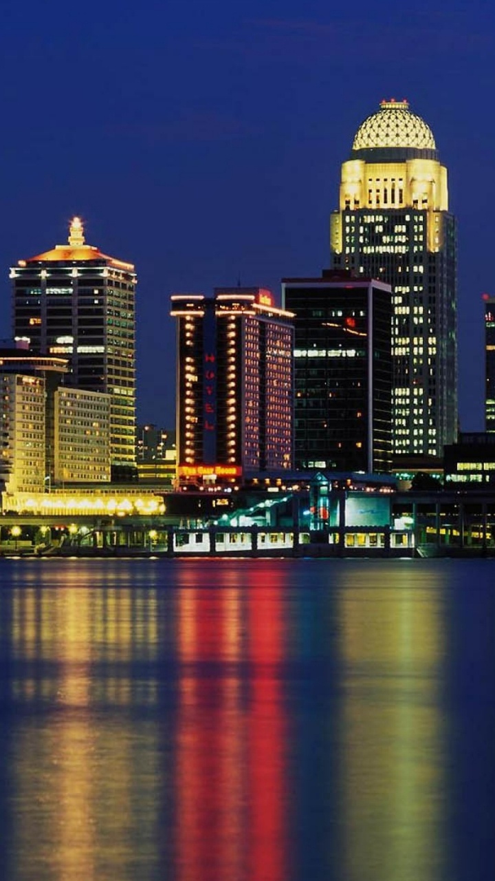 City Skyline Across Body of Water During Night Time. Wallpaper in 720x1280 Resolution