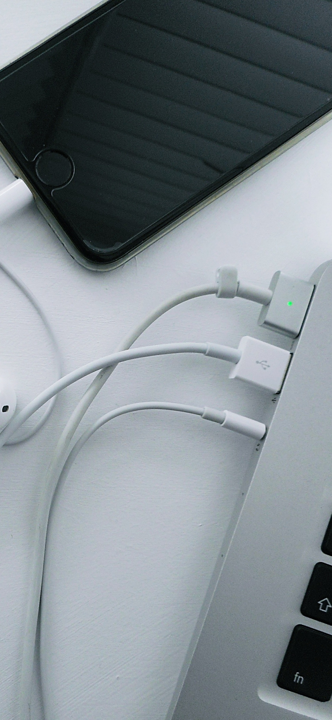 White Earbuds on White Table. Wallpaper in 1125x2436 Resolution