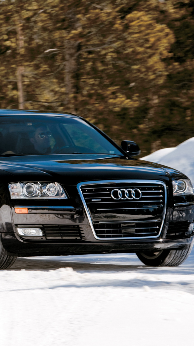 Schwarzer Audi a 4 Auf Schneebedecktem Grund. Wallpaper in 750x1334 Resolution