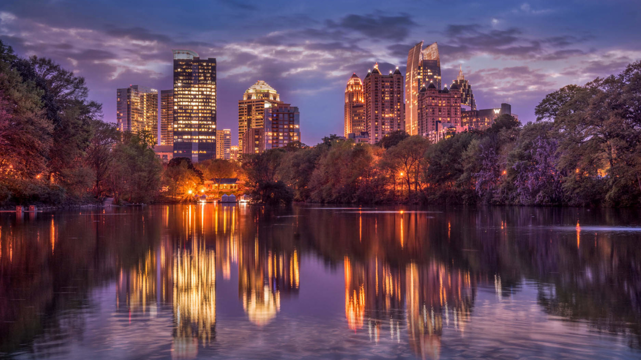 Body of Water Near City Buildings During Night Time. Wallpaper in 1280x720 Resolution