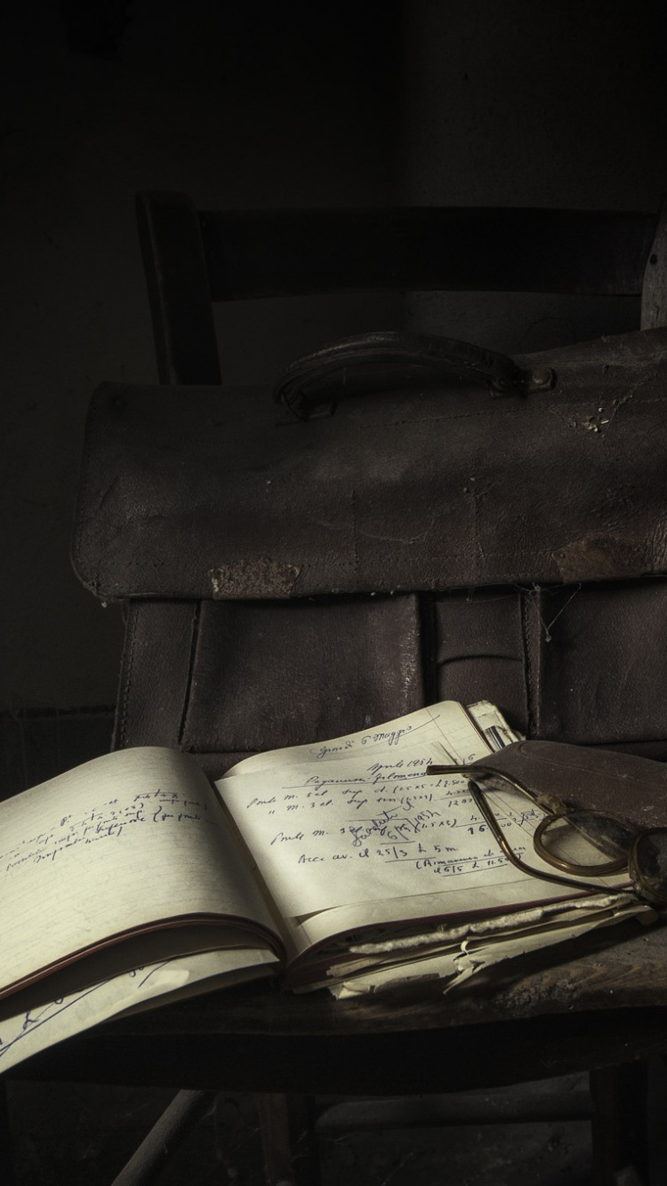 Brown Leather Bag on Brown Wooden Table. Wallpaper in 750x1334 Resolution