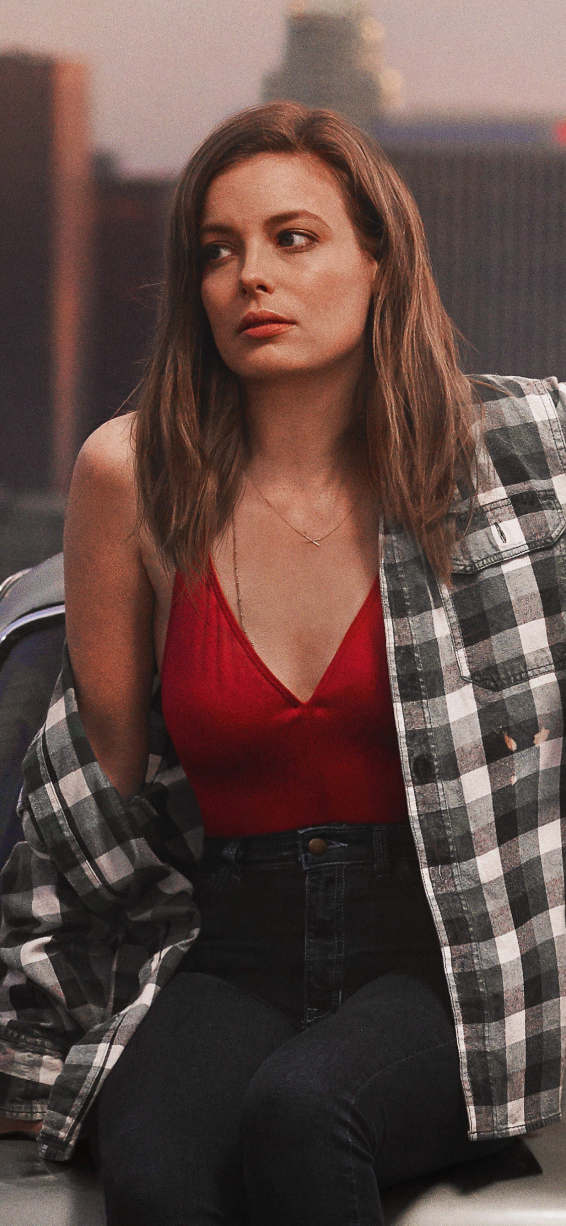 Woman in Red Tank Top Sitting Beside Man in Gray and Black Plaid Dress Shirt. Wallpaper in 1125x2436 Resolution