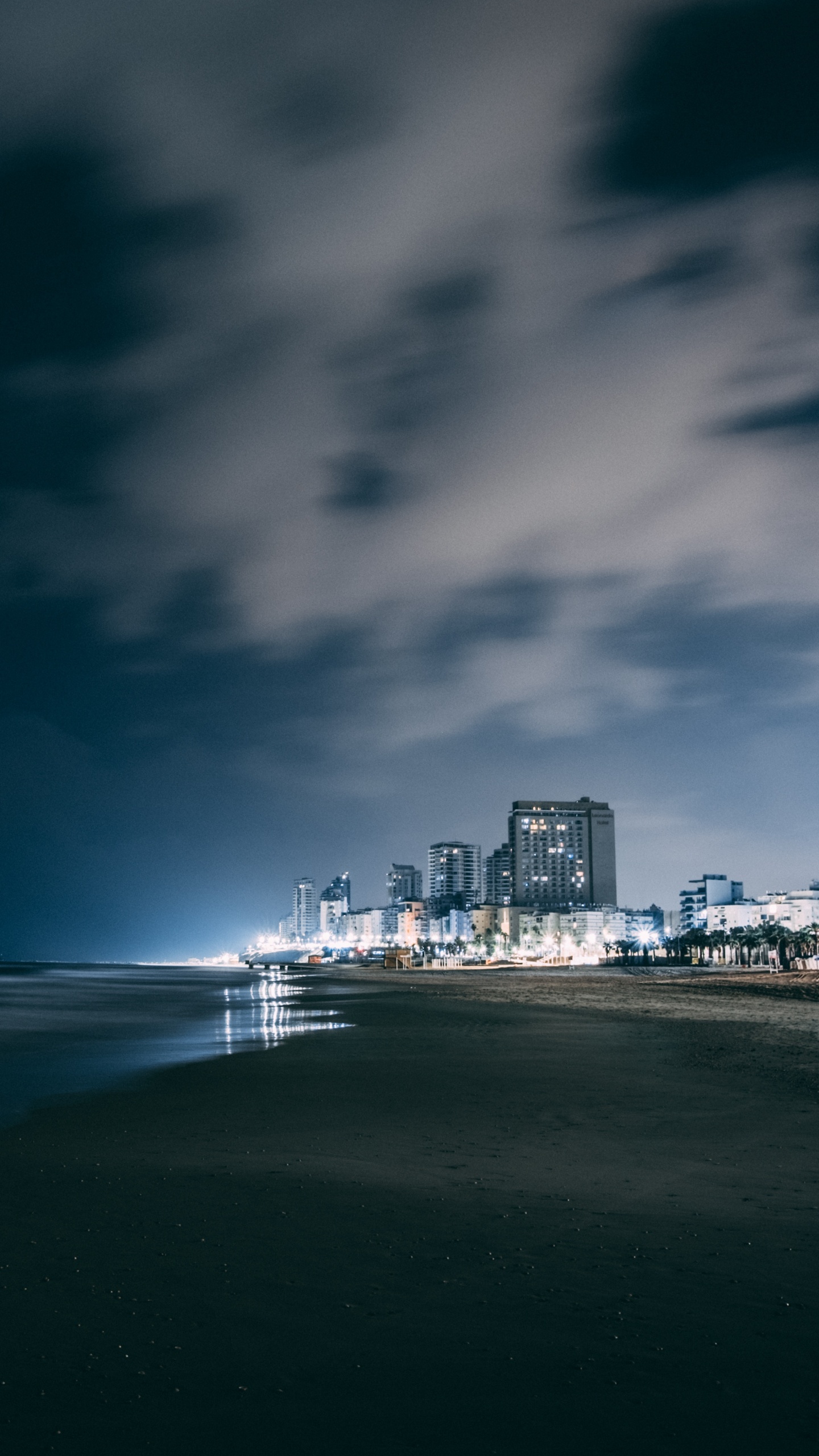 City Skyline Across Body of Water During Night Time. Wallpaper in 1440x2560 Resolution