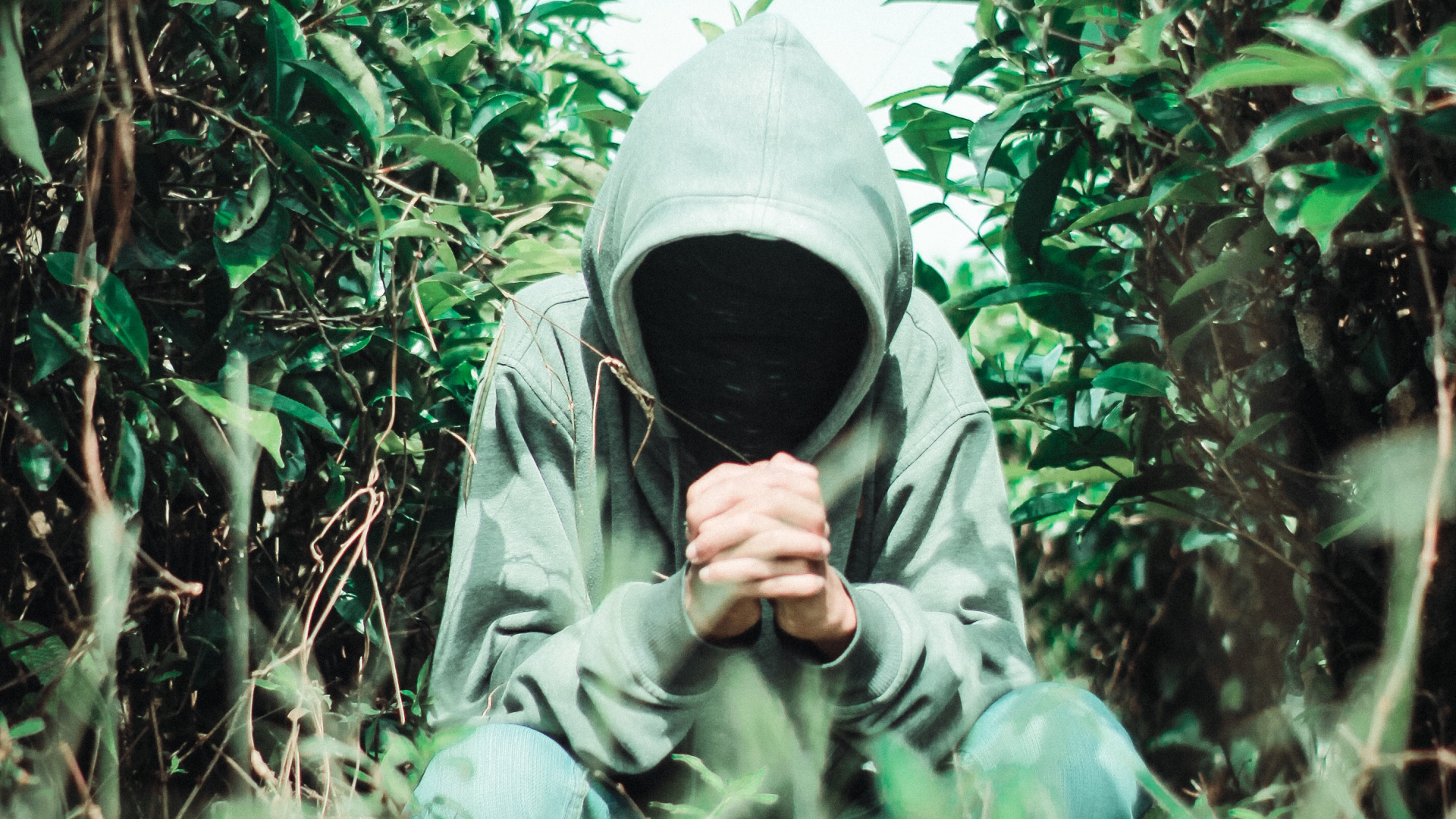 Man in Gray Hoodie Standing on Green Grass Field. Wallpaper in 1920x1080 Resolution