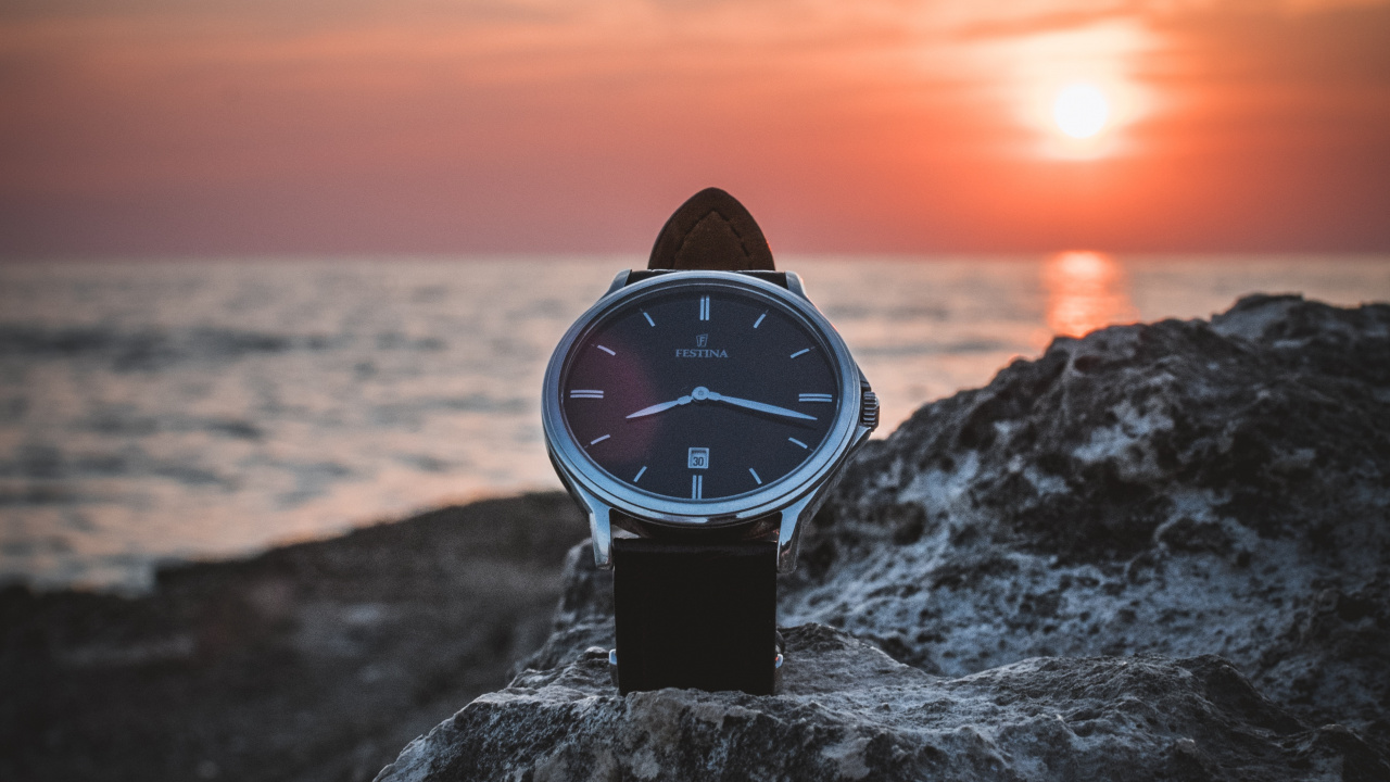 Black and White Analog Watch on Gray Rock Near Sea During Sunset. Wallpaper in 1280x720 Resolution