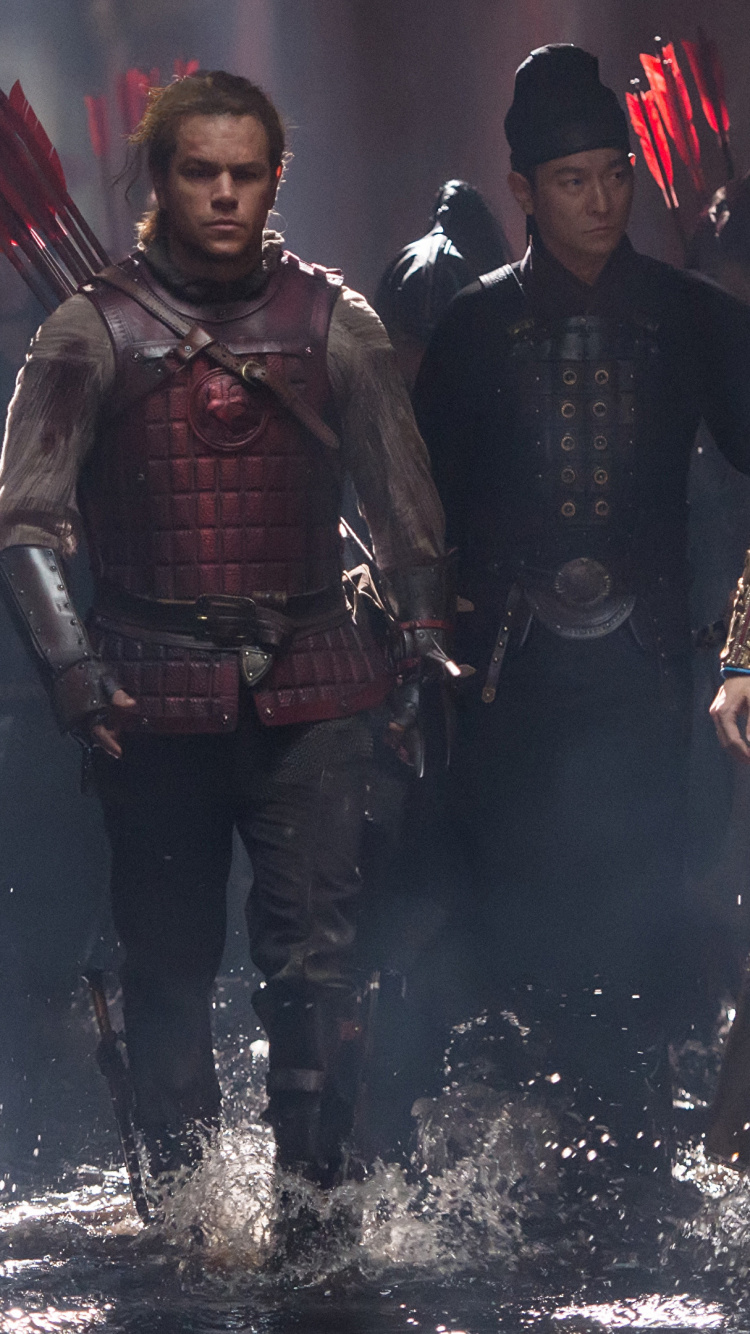 Man in Black and Red Suit Holding Black Rifle. Wallpaper in 750x1334 Resolution