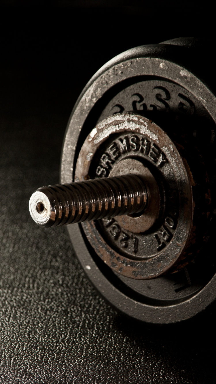 Silberne Und Schwarze Hantel Auf Schwarzem Textil. Wallpaper in 750x1334 Resolution