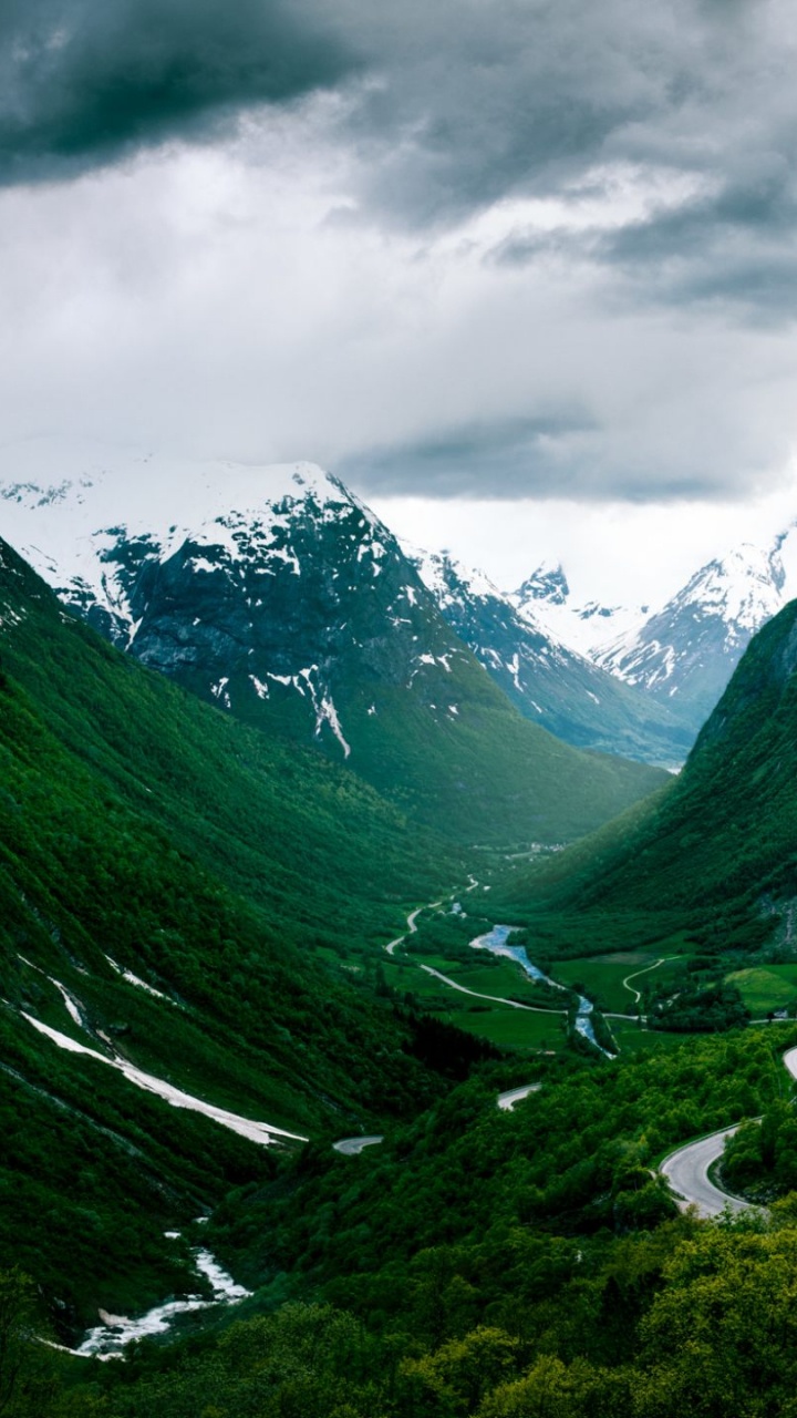 Green Mountains Under Gray Clouds. Wallpaper in 720x1280 Resolution