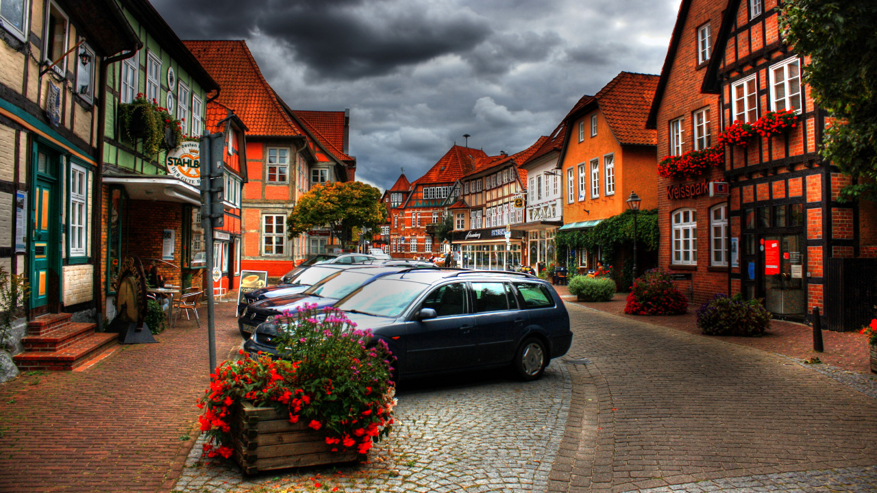 Black Station Wagon Parked Beside Brown Concrete Building During Daytime. Wallpaper in 1280x720 Resolution