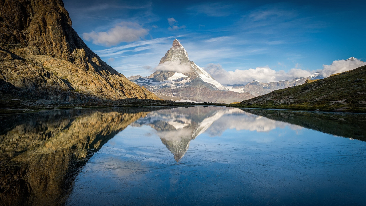 Green Mountain Beside Body of Water Under Blue Sky During Daytime. Wallpaper in 1280x720 Resolution