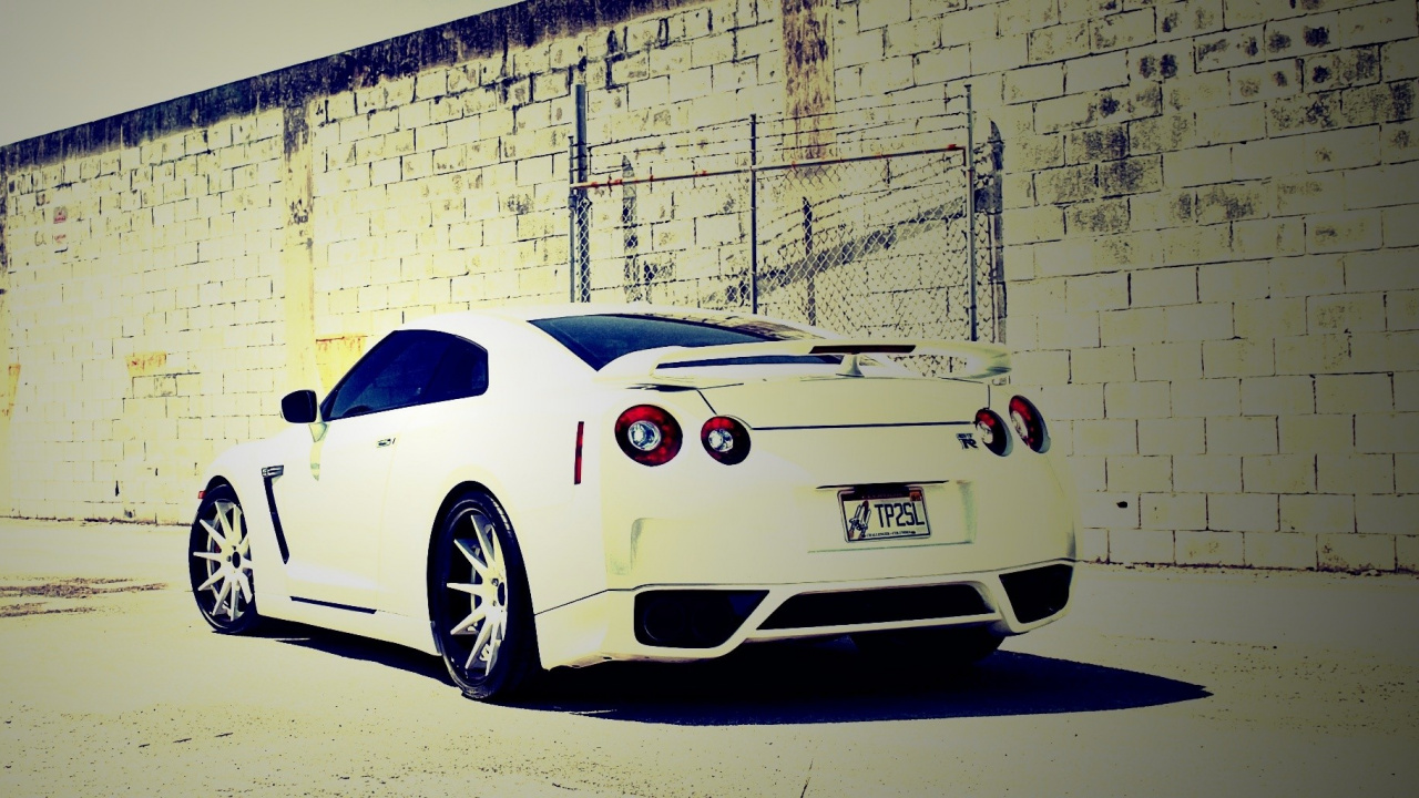 White Porsche 911 Parked Beside White Brick Wall. Wallpaper in 1280x720 Resolution