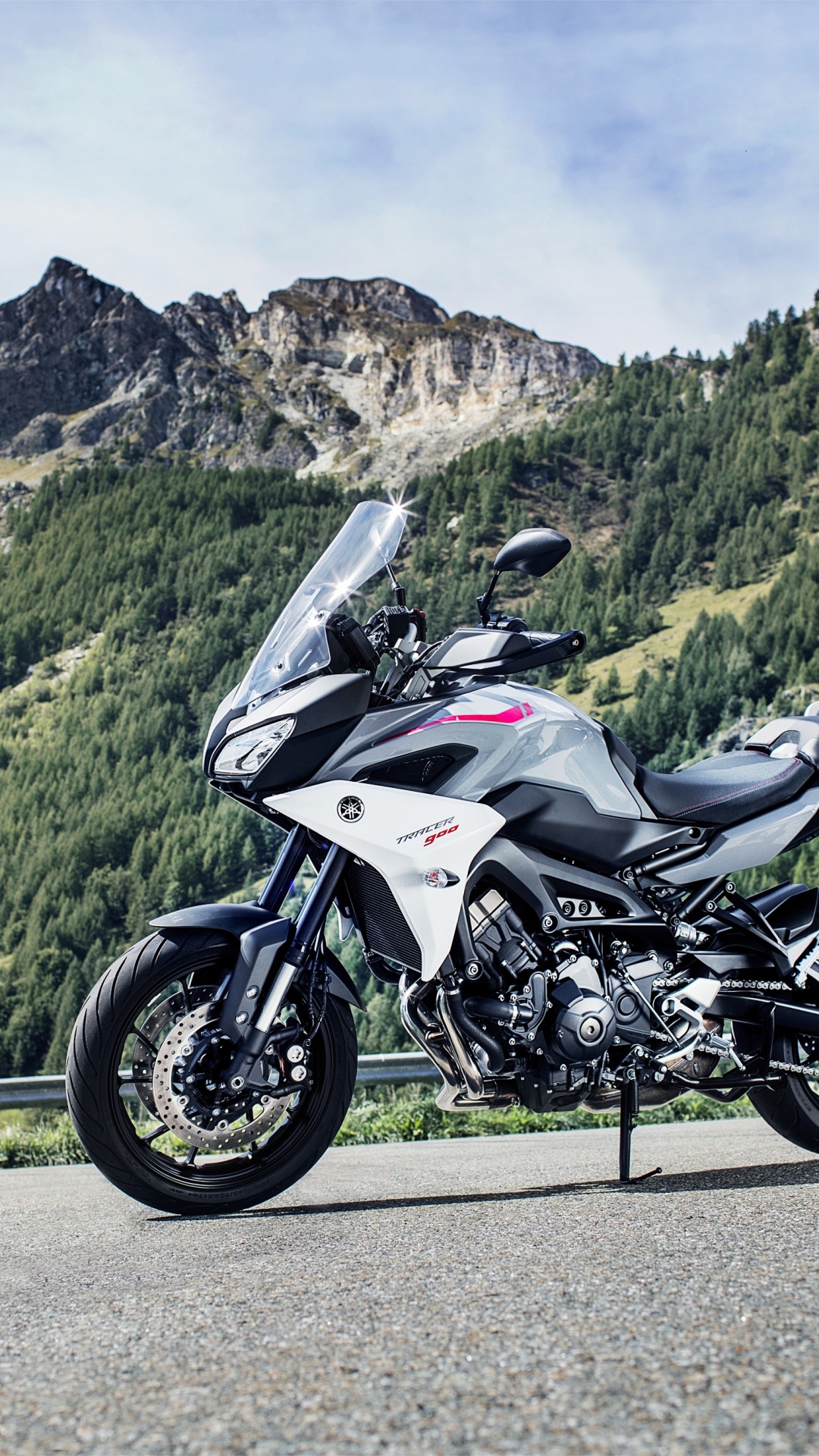 White and Black Sports Bike Parked on Green Grass Field Near Green Mountains During Daytime. Wallpaper in 1080x1920 Resolution