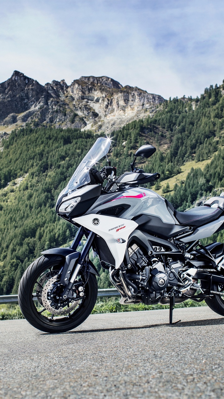 White and Black Sports Bike Parked on Green Grass Field Near Green Mountains During Daytime. Wallpaper in 720x1280 Resolution