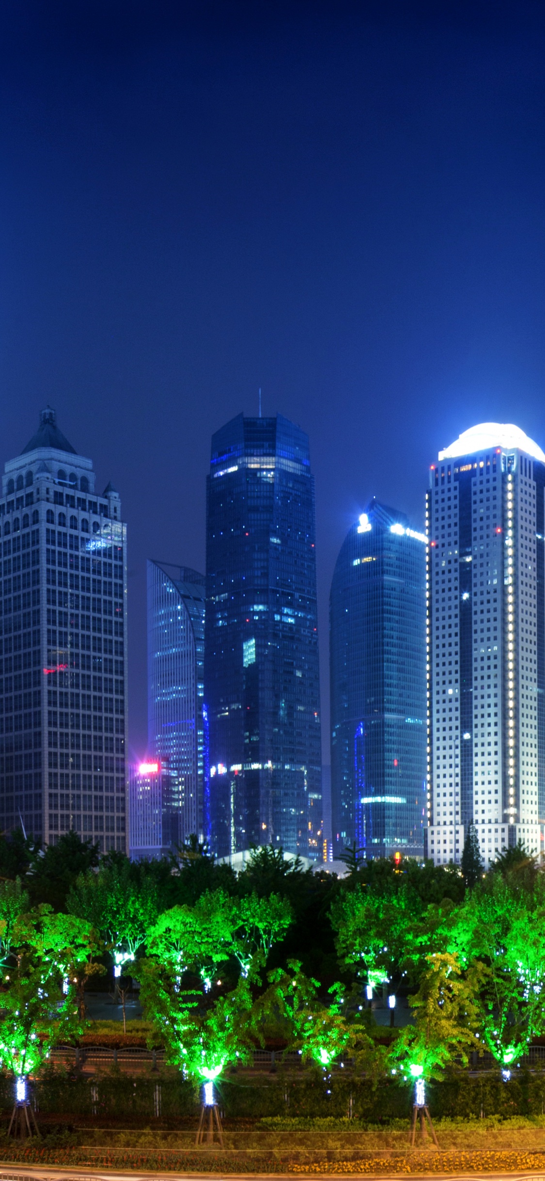 City Buildings With Lights Turned on During Night Time. Wallpaper in 1125x2436 Resolution