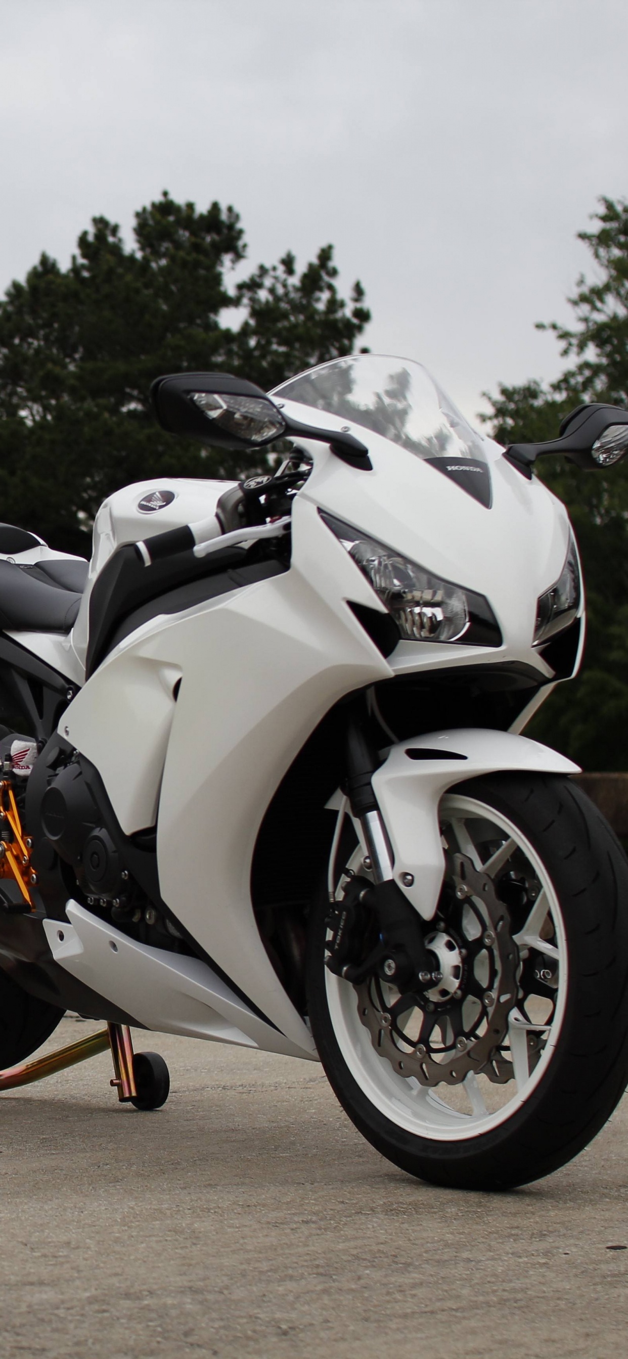 Black and White Sports Bike Parked on Brown Dirt Road During Daytime. Wallpaper in 1242x2688 Resolution