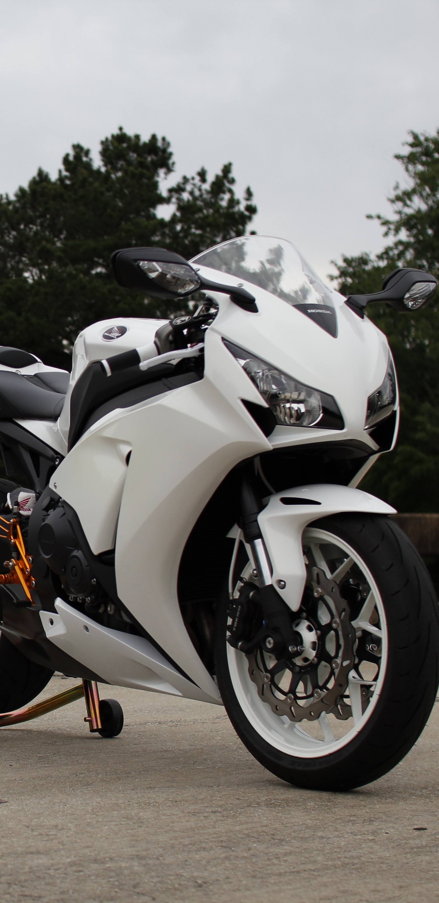Black and White Sports Bike Parked on Brown Dirt Road During Daytime. Wallpaper in 1440x2960 Resolution