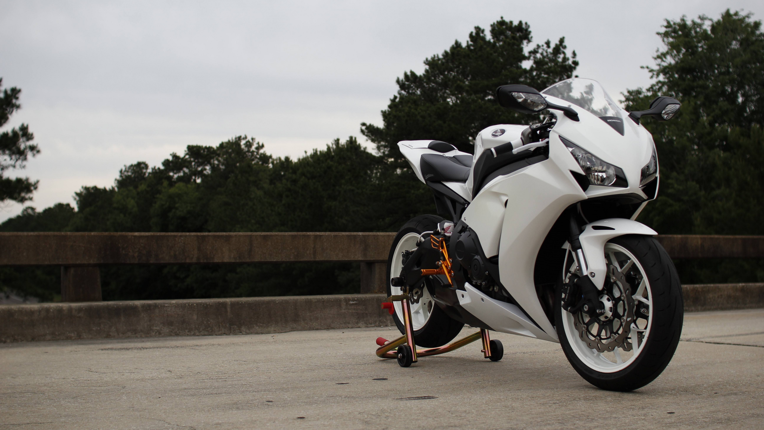 Black and White Sports Bike Parked on Brown Dirt Road During Daytime. Wallpaper in 2560x1440 Resolution
