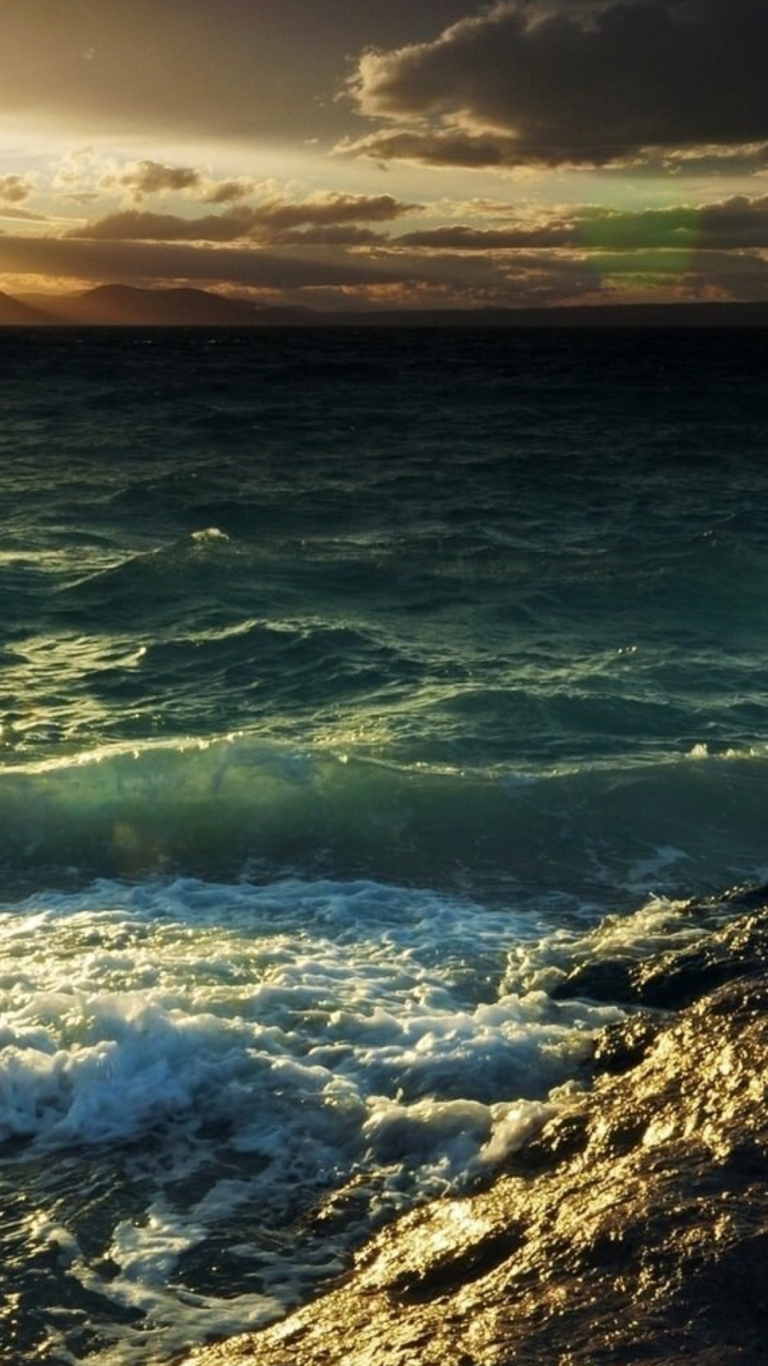 Ocean Waves Crashing on Shore During Sunset. Wallpaper in 1080x1920 Resolution