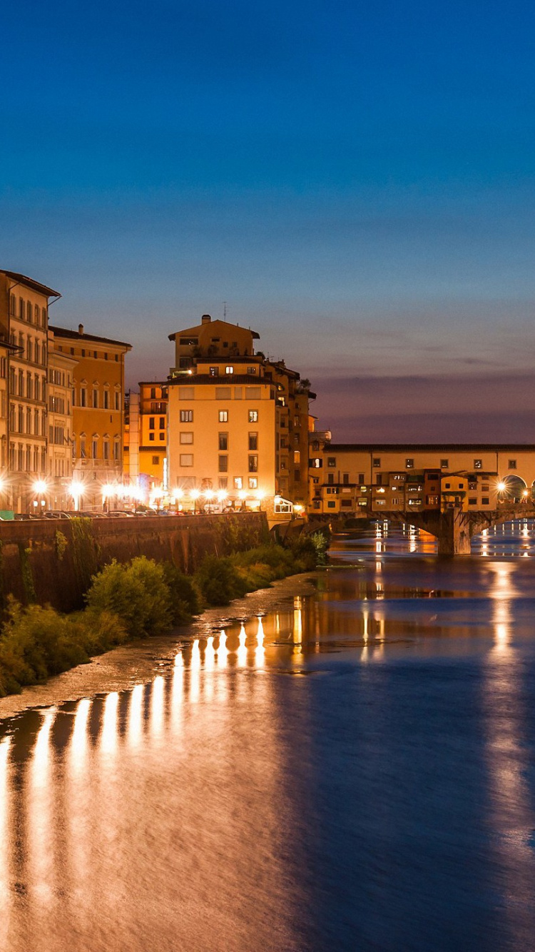 Body of Water Between Buildings During Night Time. Wallpaper in 750x1334 Resolution
