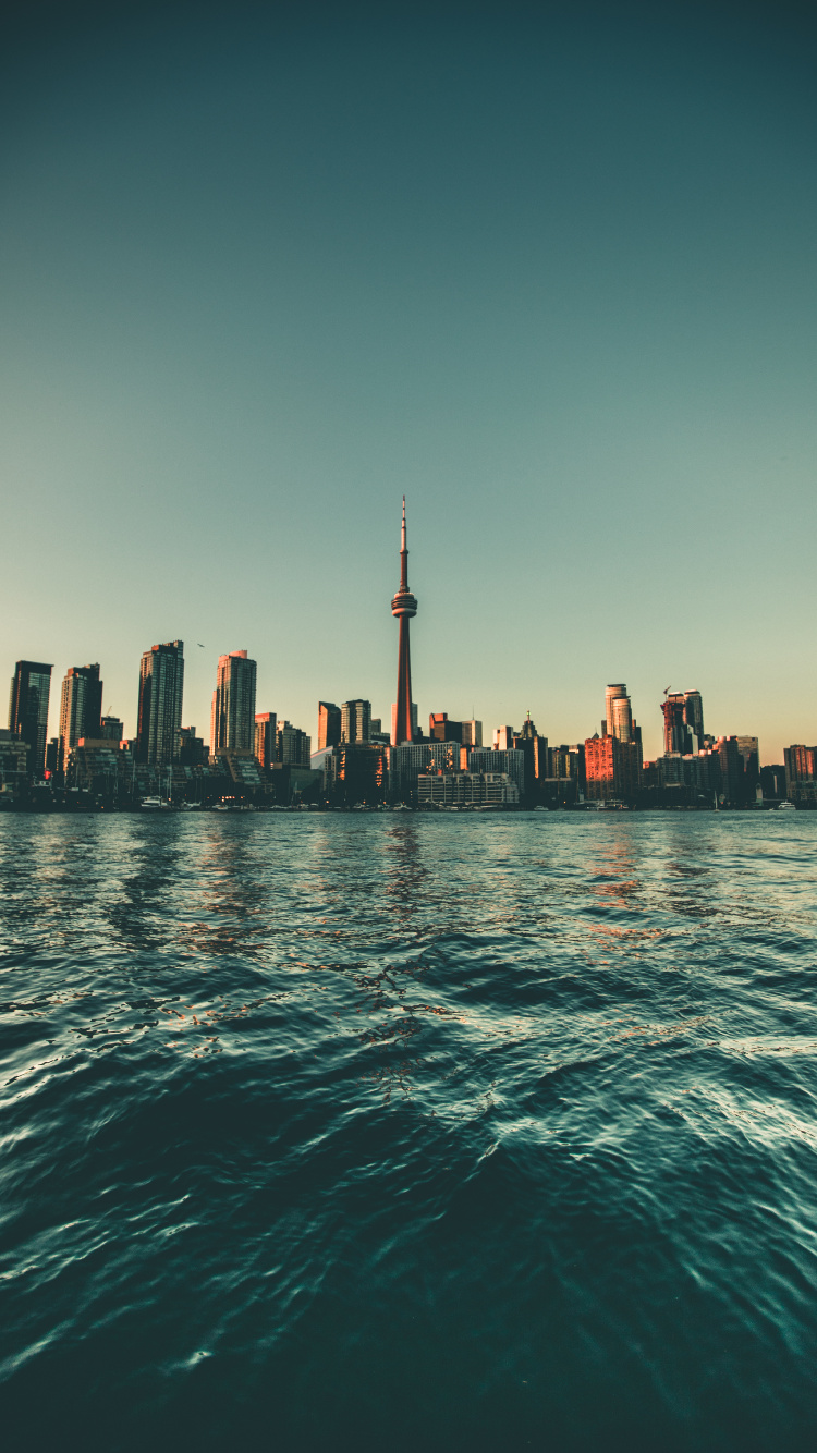 City Skyline Across Body of Water During Daytime. Wallpaper in 750x1334 Resolution