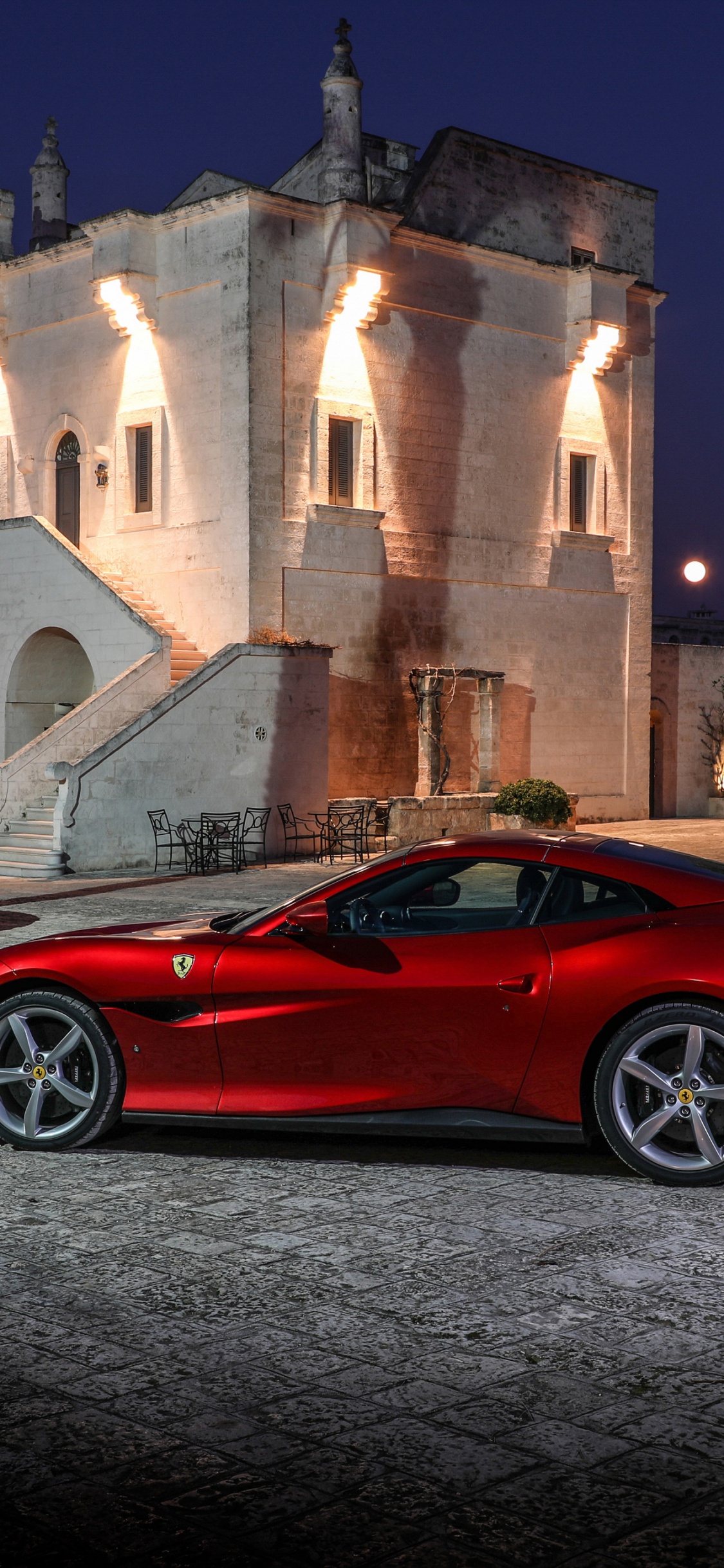 Red Ferrari 458 Italia Parked Near Brown Concrete Building During Night Time. Wallpaper in 1125x2436 Resolution