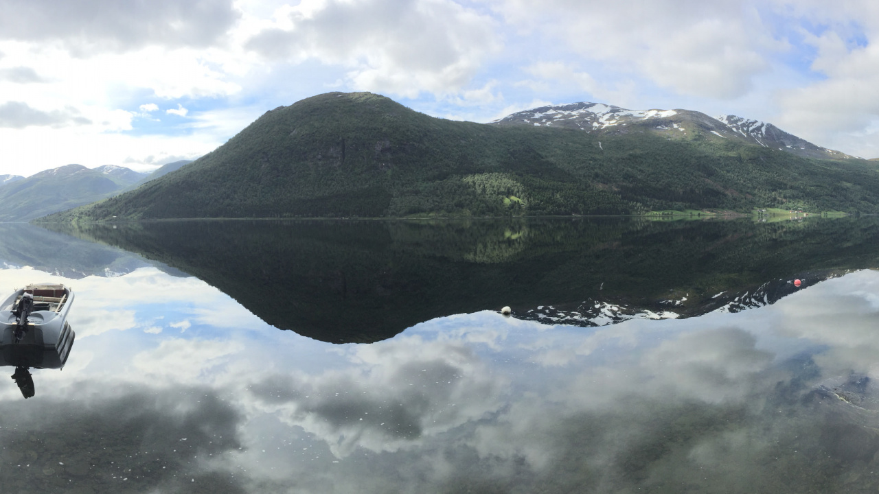 Green Mountain Beside Body of Water During Daytime. Wallpaper in 1280x720 Resolution