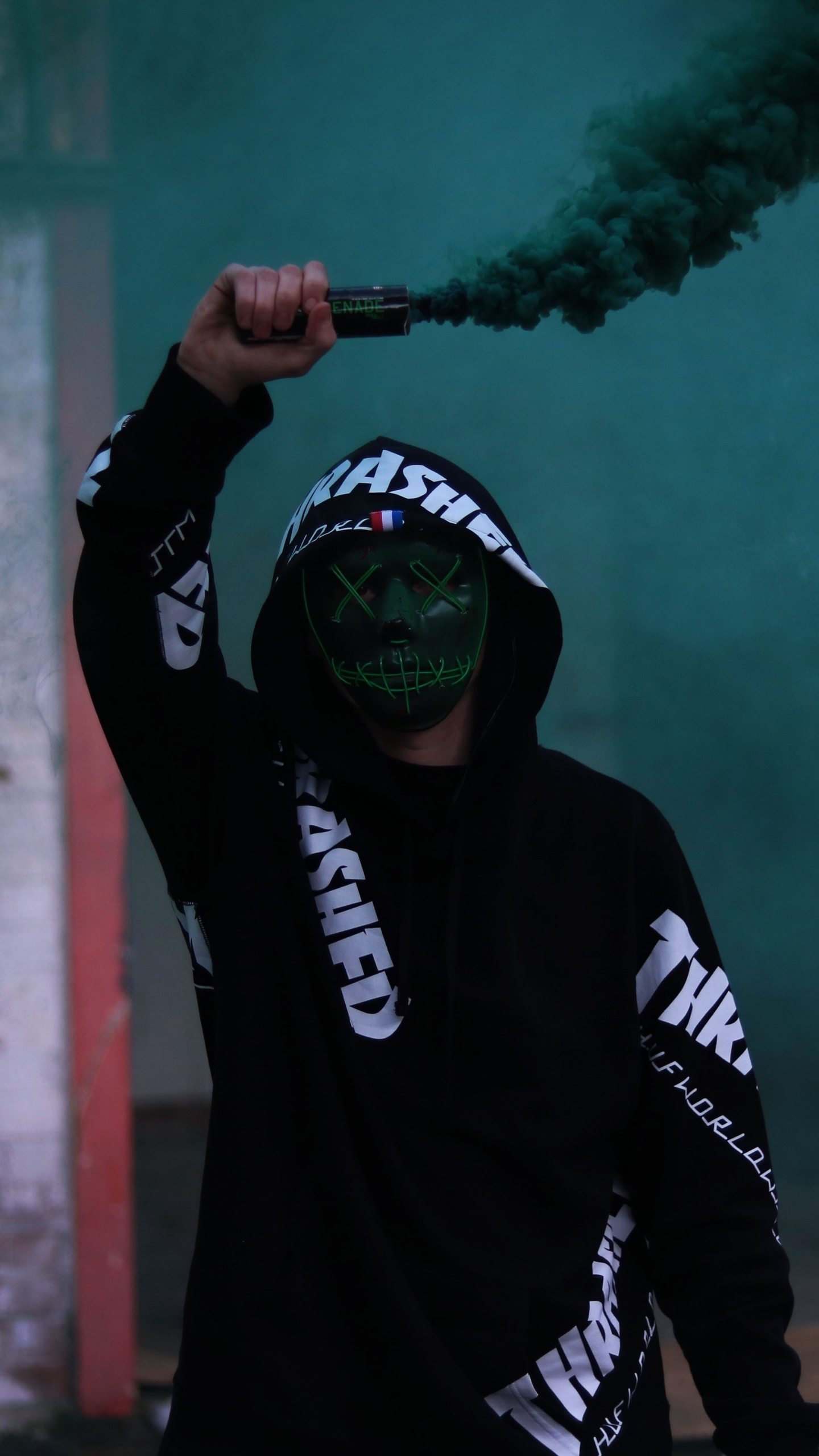 Man in Black and White Adidas Hoodie Holding Green Smoke. Wallpaper in 1440x2560 Resolution
