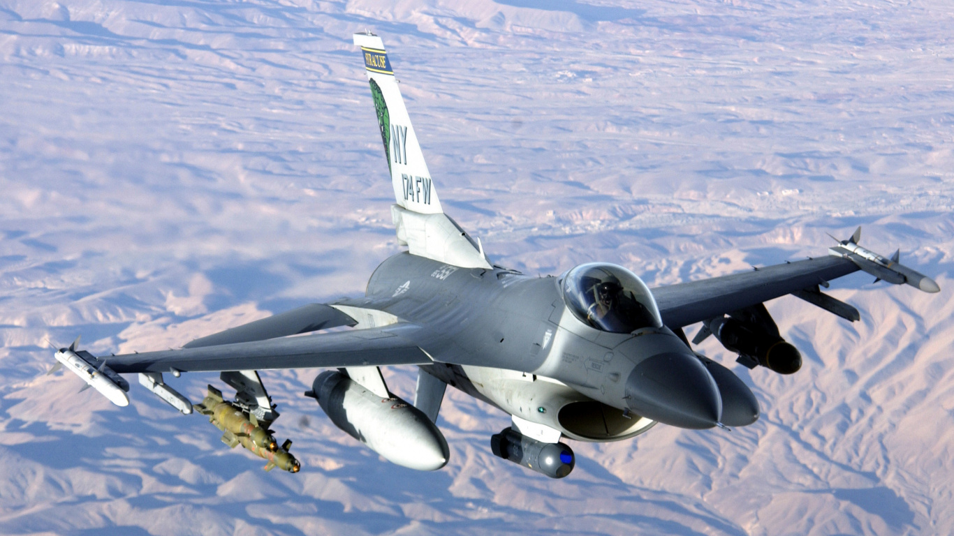 Gray Fighter Plane Flying Over The Mountains During Daytime. Wallpaper in 1366x768 Resolution