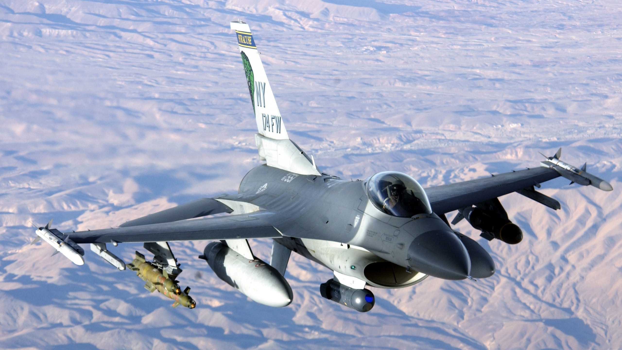 Gray Fighter Plane Flying Over The Mountains During Daytime. Wallpaper in 2560x1440 Resolution