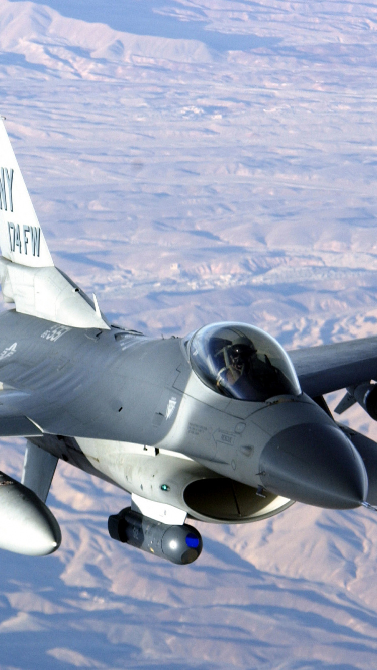 Gray Fighter Plane Flying Over The Mountains During Daytime. Wallpaper in 750x1334 Resolution