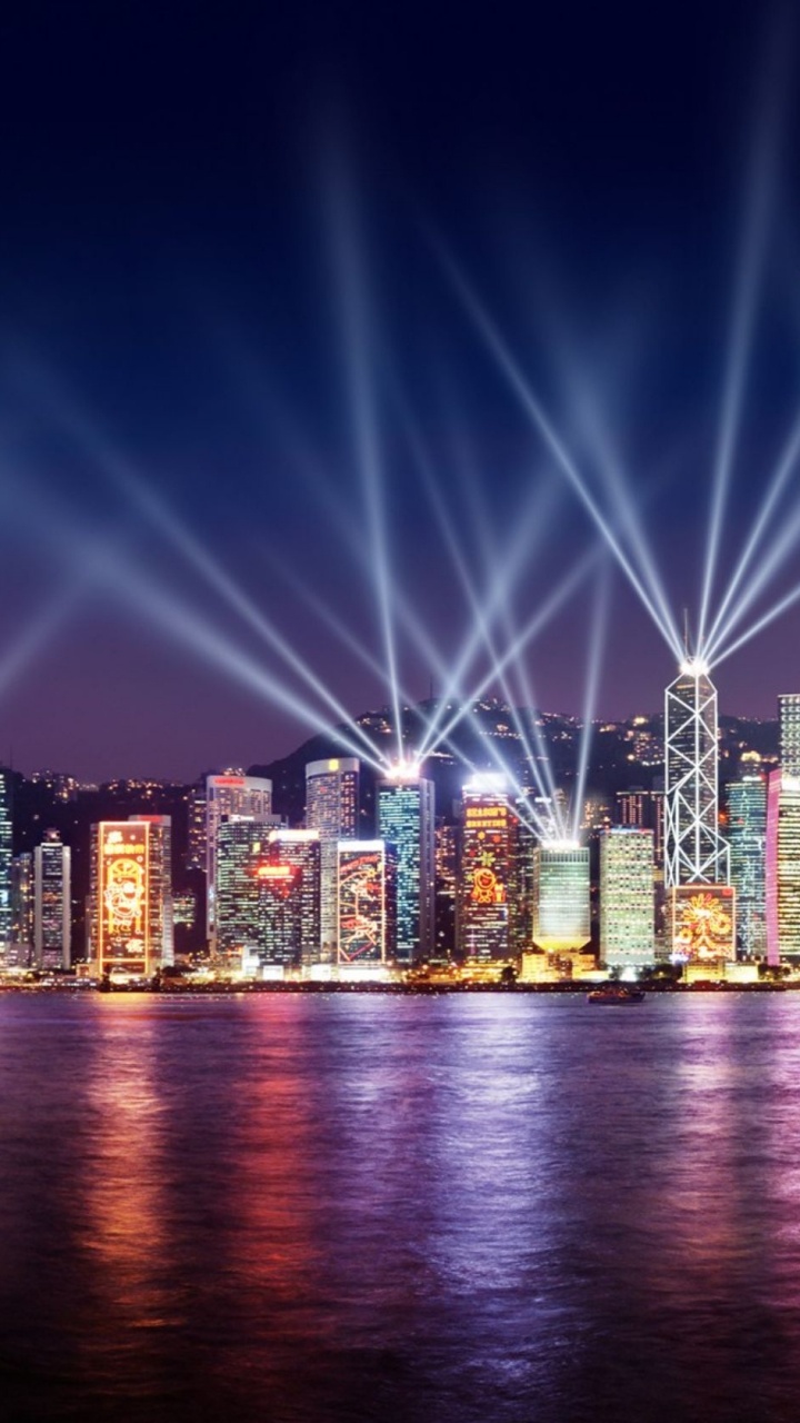 City Lights Turned on During Night Time. Wallpaper in 720x1280 Resolution