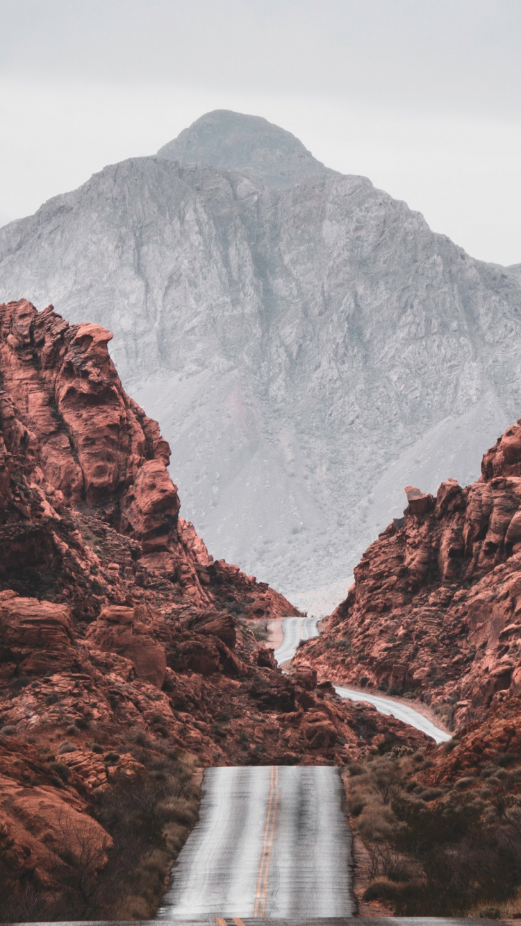 Brown Rocky Mountain Under Blue Sky During Daytime. Wallpaper in 750x1334 Resolution