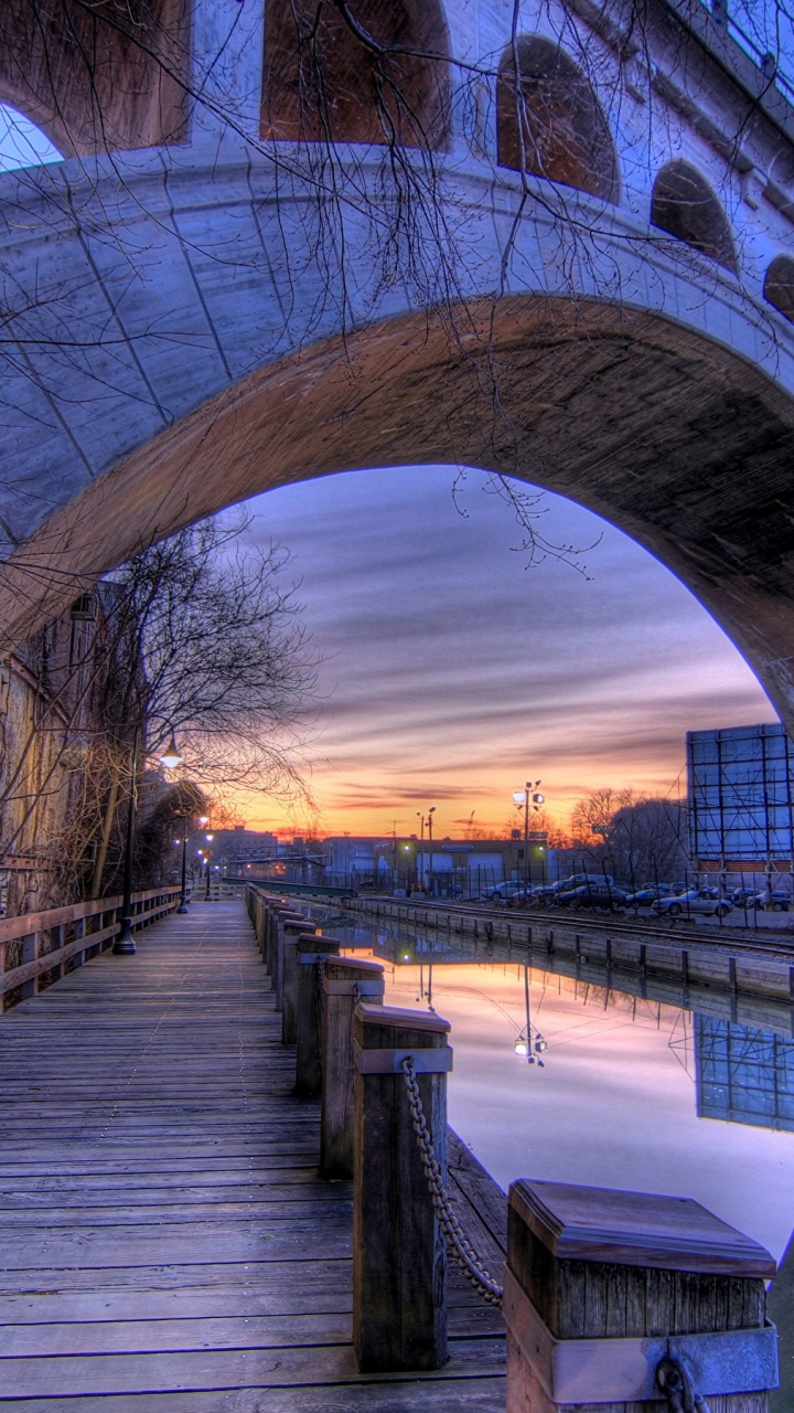 Brown Wooden Bridge Over River During Sunset. Wallpaper in 720x1280 Resolution