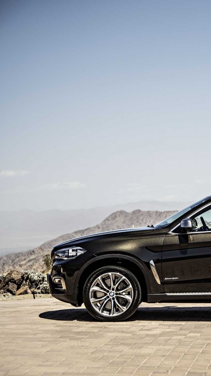 Black Sedan on Gray Concrete Road During Daytime. Wallpaper in 720x1280 Resolution