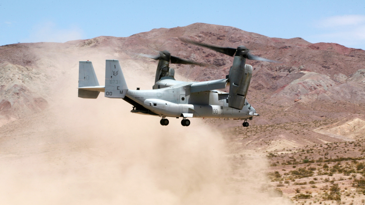 Gray Fighter Jet Flying Over Brown Mountain During Daytime. Wallpaper in 1280x720 Resolution