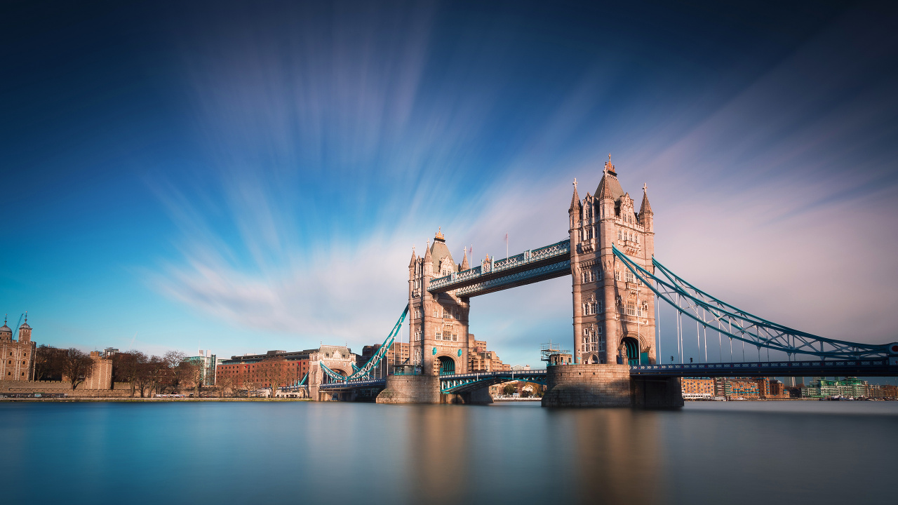 Brown Bridge Over River Under Blue Sky. Wallpaper in 1280x720 Resolution