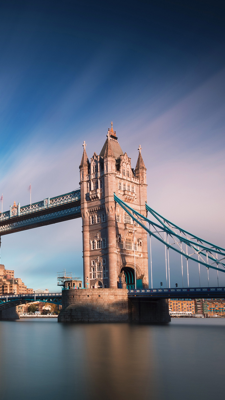 Brown Bridge Over River Under Blue Sky. Wallpaper in 750x1334 Resolution