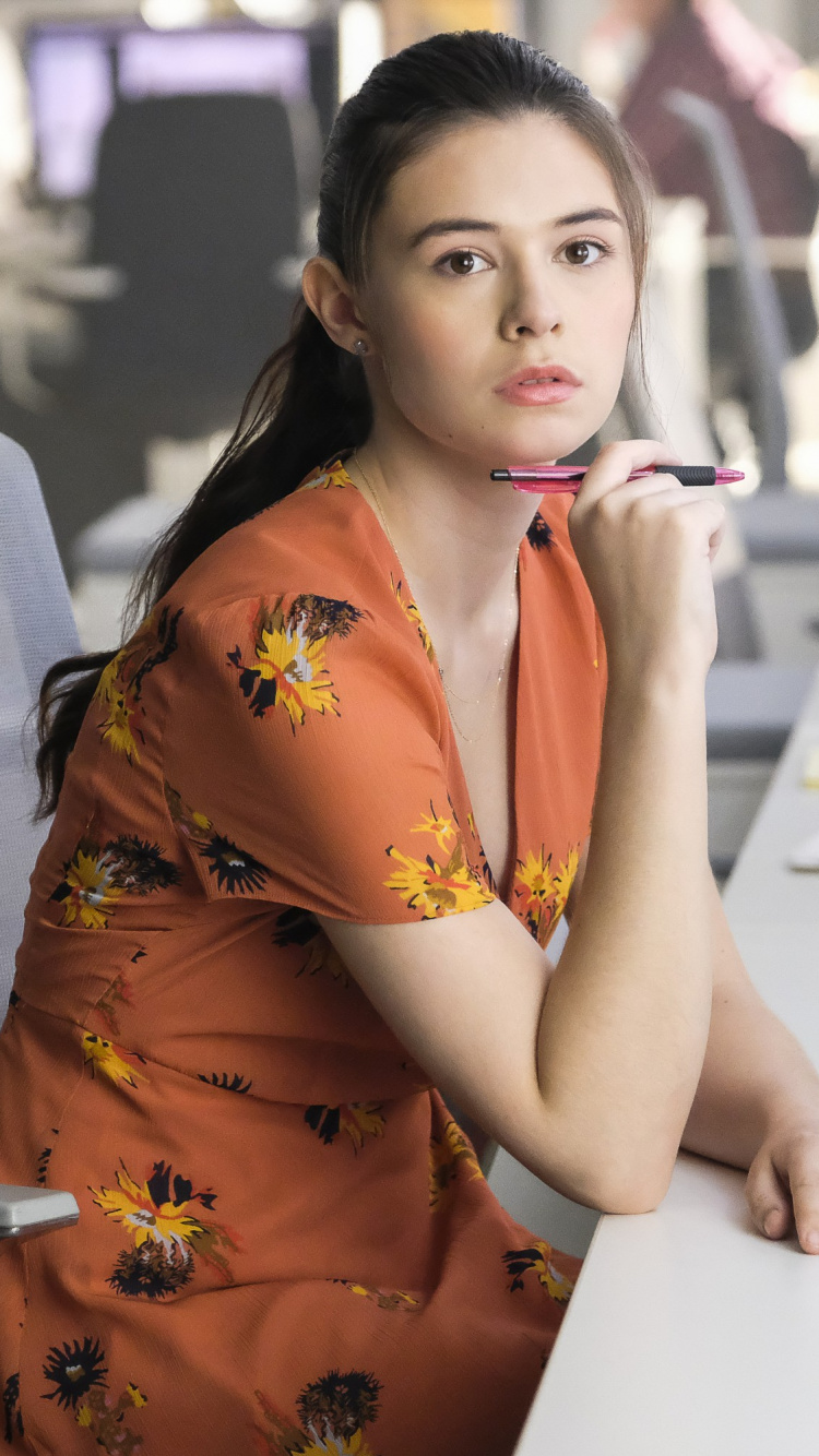 Woman in Orange and Yellow Floral Dress Sitting on Chair. Wallpaper in 750x1334 Resolution