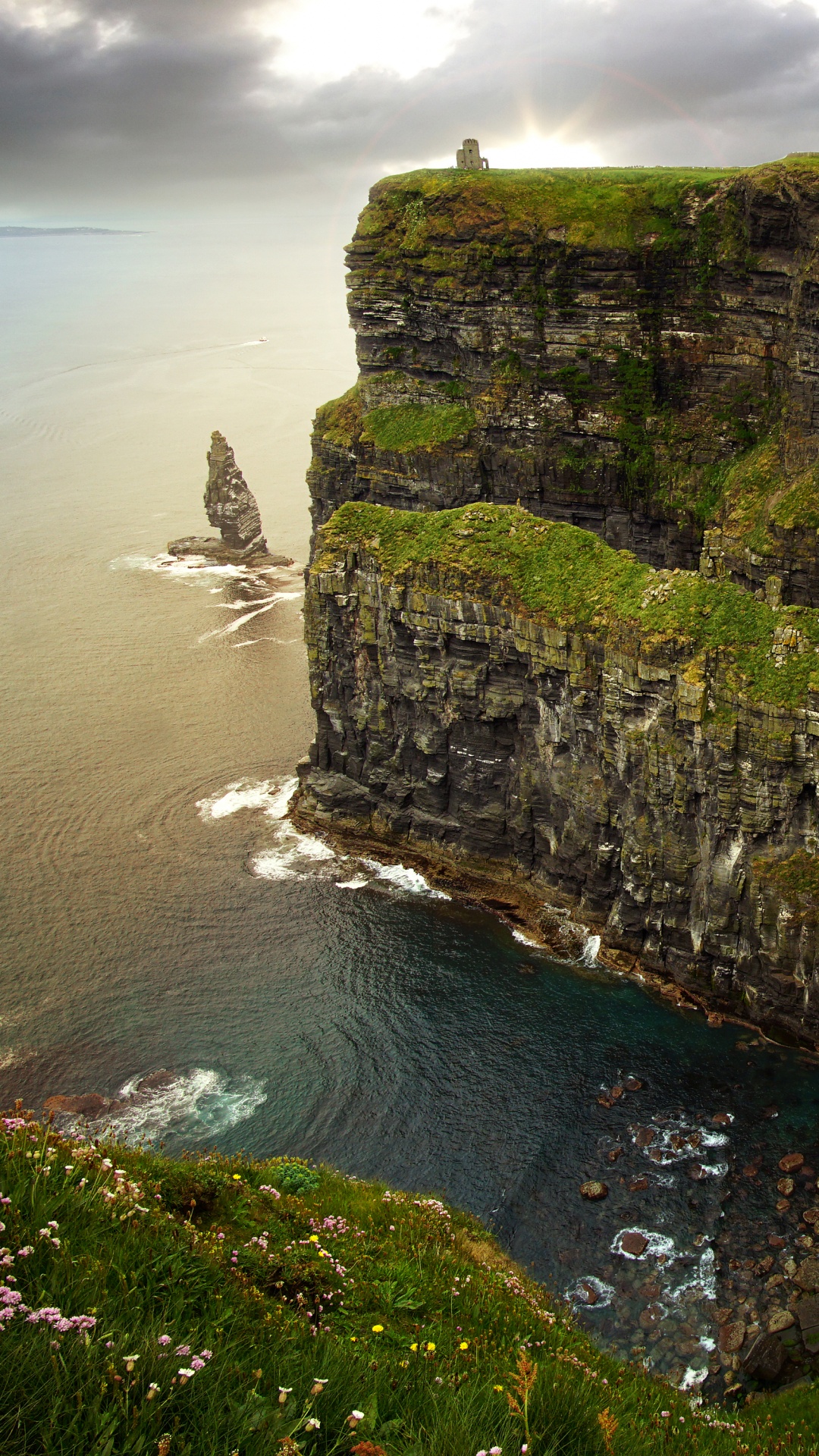 Gray and Green Rock Formation Beside Body of Water During Daytime. Wallpaper in 1080x1920 Resolution