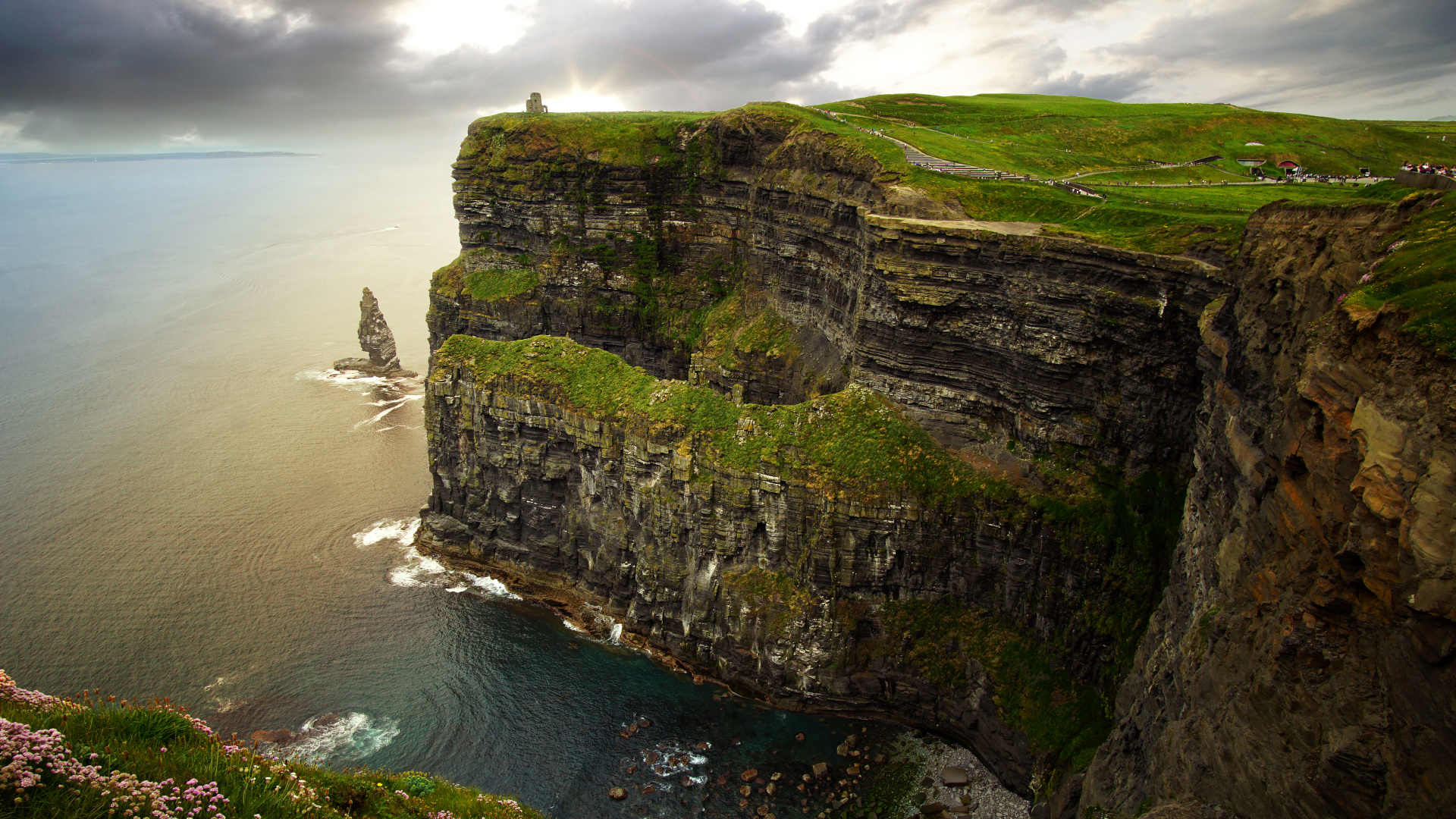 Gray and Green Rock Formation Beside Body of Water During Daytime. Wallpaper in 1920x1080 Resolution