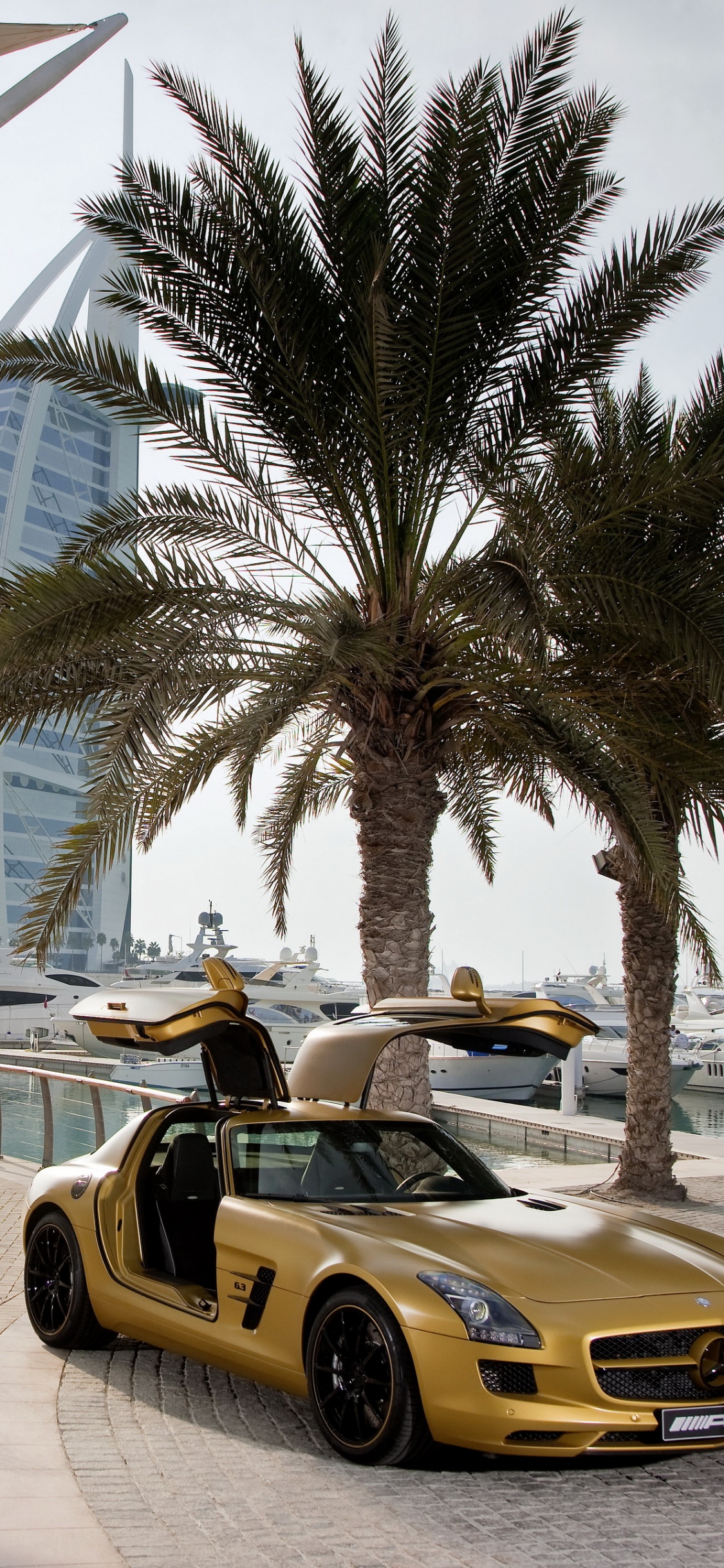 Yellow Ferrari 458 Italia on Road Near Palm Trees During Daytime. Wallpaper in 1125x2436 Resolution